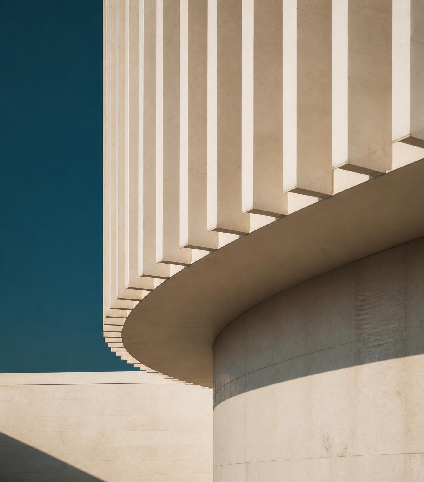 Abstract modernist facade with rhythmic vertical structure and soft shadows